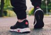 Sepatu Kebesaran, Kamu bisa Atasi dengan Tips yang Berikut Ini person in black sneakers walking on street