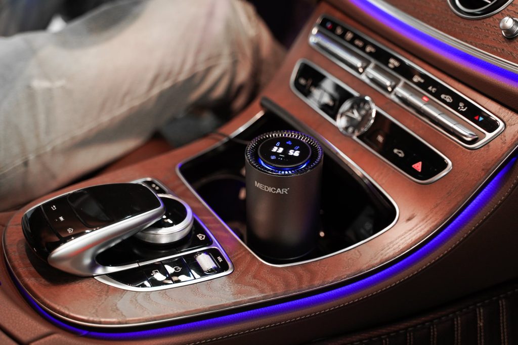 car air purifier in the storage compartment in the center console of a mercedes
