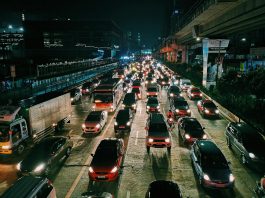 photo of vehicles on road during evening